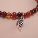 Close-up of flower red agate bracelet with silver details.