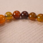 Close-up of flower red agate bracelet with unique patterns.