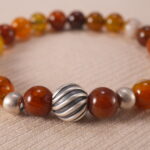 Close-up of flower red agate bracelet with unique patterns.
