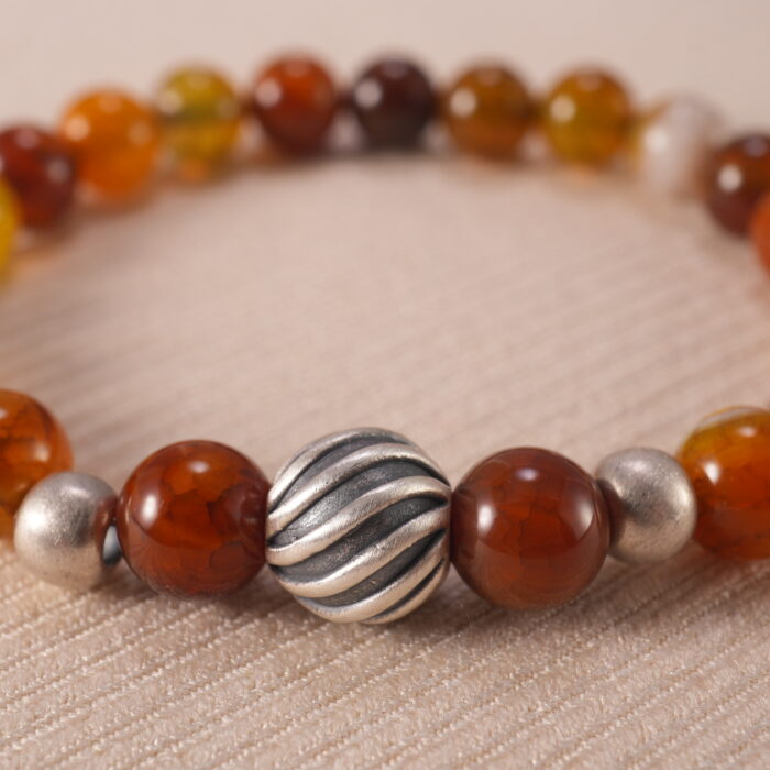 Close-up of flower red agate bracelet with unique patterns.