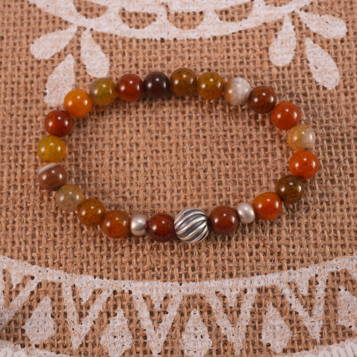 Flower red agate bracelet in daylight showing layered color.