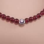 Close-up of garnet bracelet with deep red beads.