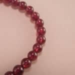 Close-up of garnet bracelet with deep red beads.