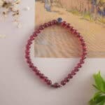 Garnet bracelet in natural light showing rich wine tones.
