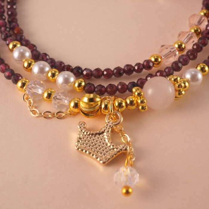 Close-up of polished Garnet beads, revealing their natural clarity and deep red luster.