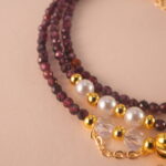 Close-up of polished Garnet beads, revealing their natural clarity and deep red luster.