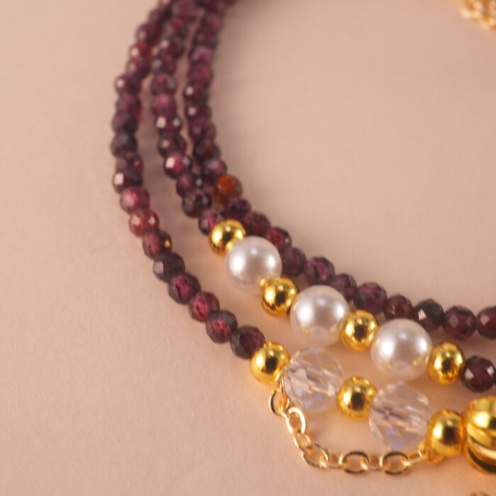 Close-up of polished Garnet beads, revealing their natural clarity and deep red luster.