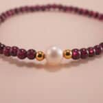 Close-up of garnet and pearl bracelet.