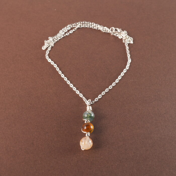 Gemini zodiac necklace with moss agate, tiger eye, and citrine gemstones.