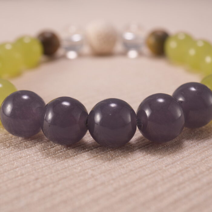 Close-up of gray agate bracelet with quartz and lava accents.