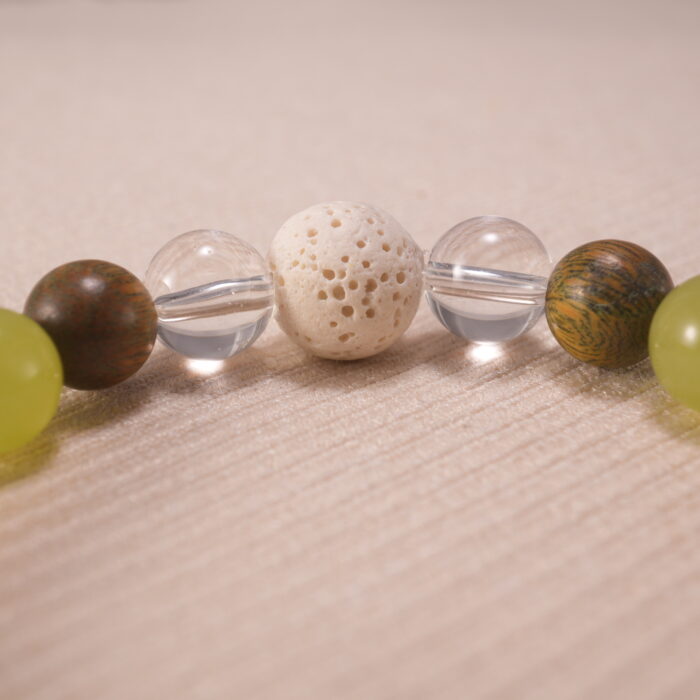 Close-up of gray agate bracelet with quartz and lava accents.