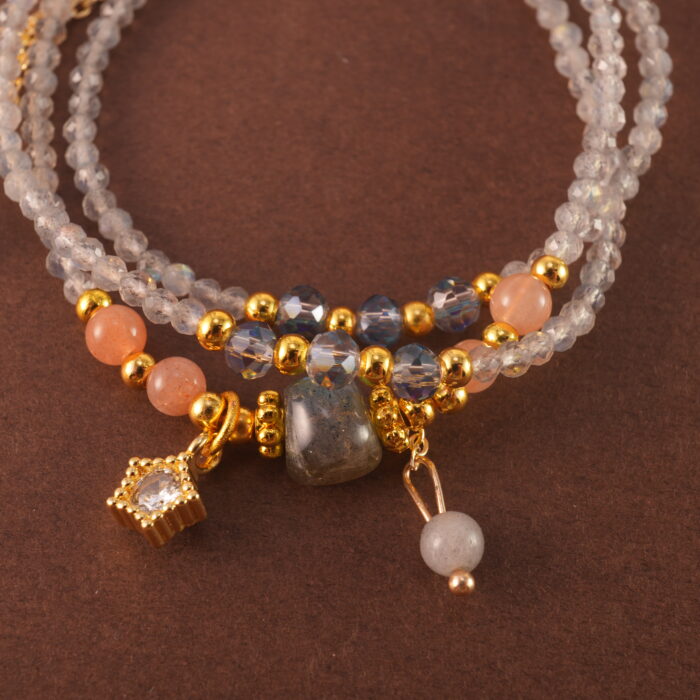 Close-up of the moonstone and quartz beads, revealing their natural shimmer and polished surfaces.