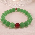 Close-up of bracelet combining green aventurine and red agate beads.