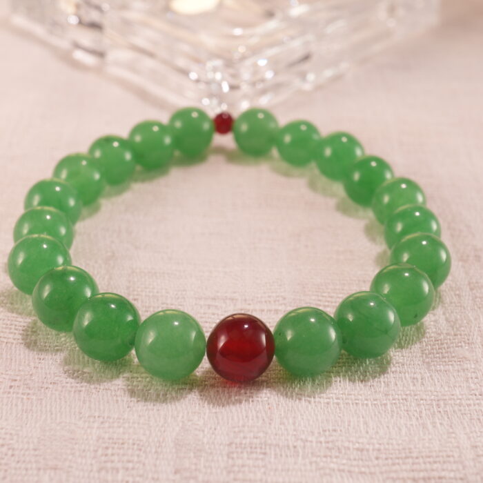 Close-up of bracelet combining green aventurine and red agate beads.