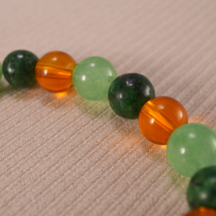 Close-up of green aventurine and citrine bracelet.