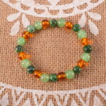 Bracelet in natural light with soft green and golden yellow hues.