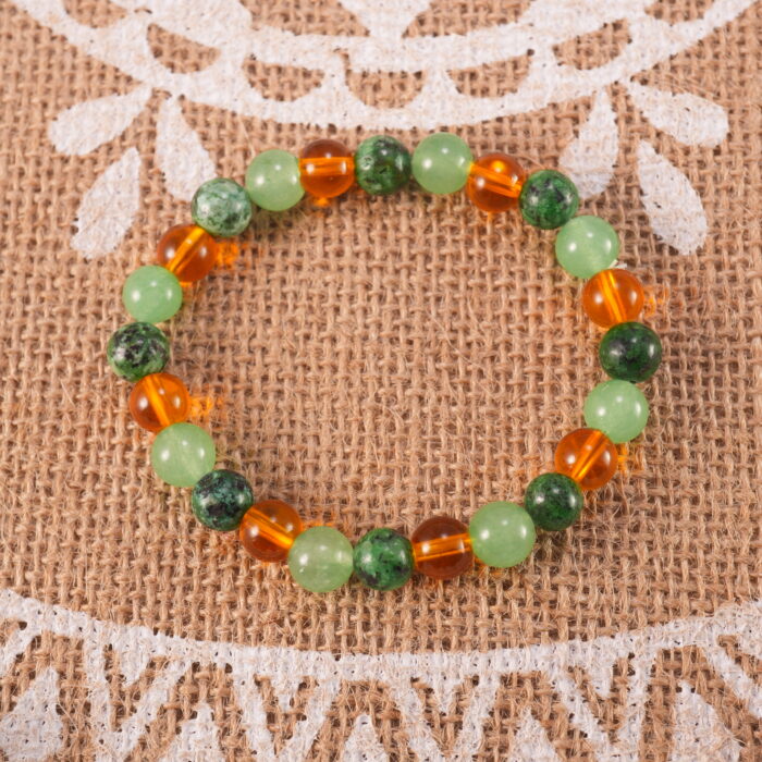 Bracelet in natural light with soft green and golden yellow hues.