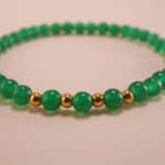 Close-up of green chalcedony bracelet with smooth finish.