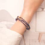 Model wearing the bracelet around the wrist, showcasing the vivid lapis color and sleek silver accents.