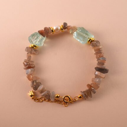 Handmade Aries bracelet with skeleton quartz, pearl, and aquamarine beads in a balanced, elegant layout.