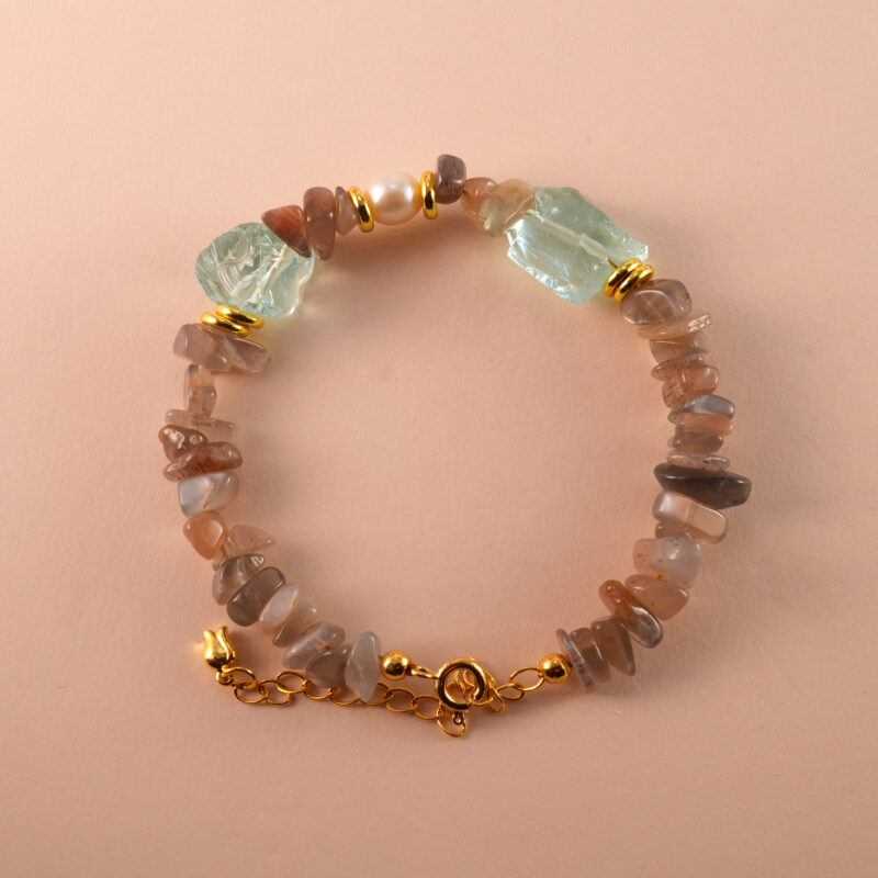 Handmade Aries bracelet with skeleton quartz, pearl, and aquamarine beads in a balanced, elegant layout.