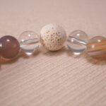 Detailed view of textured lava beads paired with polished agate and quartz – highlighting the bracelet's natural materials.