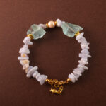 Handmade Cancer bracelet featuring Blue Lace Agate, pearl, and aquamarine in a calming pastel palette.
