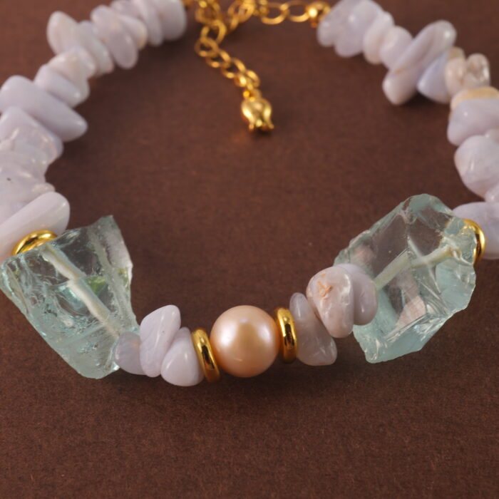 Close-up of the delicate textures in Blue Lace Agate and the refined finish of pearl and aquamarine beads.