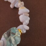 Close-up of the delicate textures in Blue Lace Agate and the refined finish of pearl and aquamarine beads.