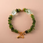 Handmade Capricorn bracelet featuring jade, pearl, and aquamarine beads in an elegant earth-toned palette.