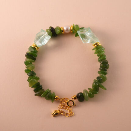 Handmade Capricorn bracelet featuring jade, pearl, and aquamarine beads in an elegant earth-toned palette.