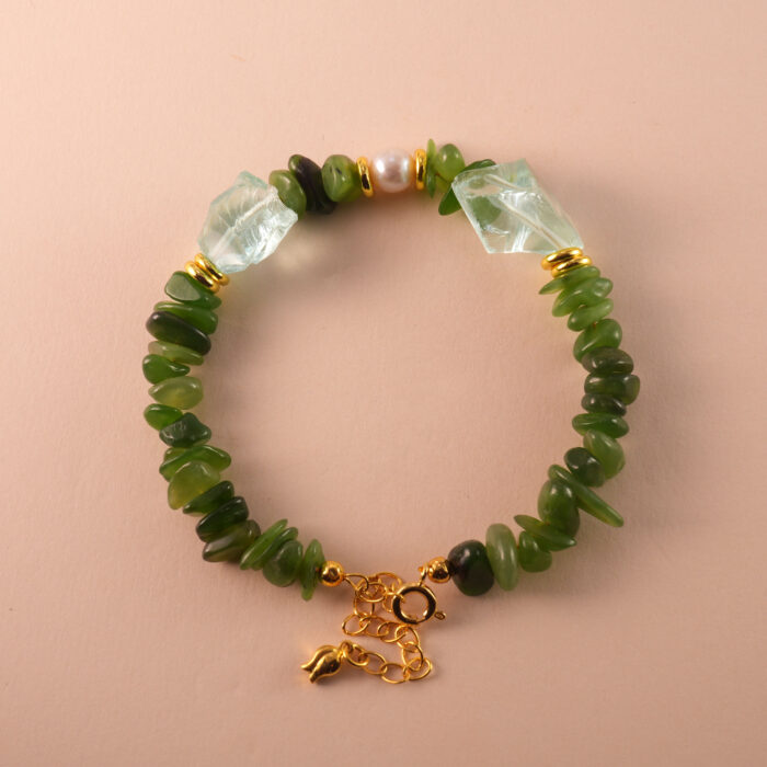 Handmade Capricorn bracelet featuring jade, pearl, and aquamarine beads in an elegant earth-toned palette.