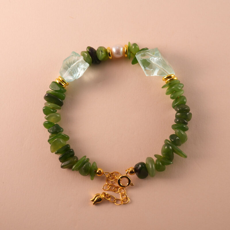 Handmade Capricorn bracelet featuring jade, pearl, and aquamarine beads in an elegant earth-toned palette.