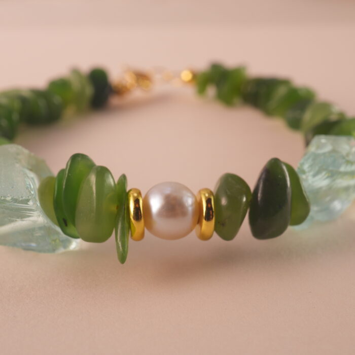 Close-up of jade, pearl, and aquamarine beads showing their natural textures and high-quality craftsmanship.