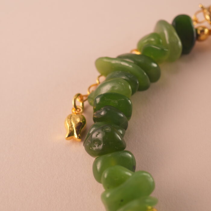 Close-up of jade, pearl, and aquamarine beads showing their natural textures and high-quality craftsmanship.