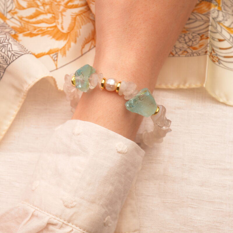 Gemini zodiac bracelet worn on the wrist, radiating a soft, luminous energy with an airy feel.