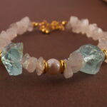 Detailed close-up showing the translucent moonstone, lustrous pearl, and sky-blue aquamarine beads strung together.