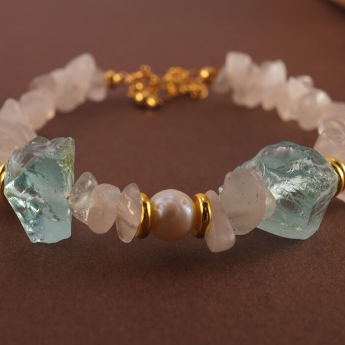 Detailed close-up showing the translucent moonstone, lustrous pearl, and sky-blue aquamarine beads strung together.