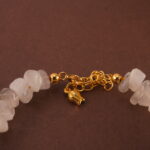 Detailed close-up showing the translucent moonstone, lustrous pearl, and sky-blue aquamarine beads strung together.
