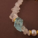Detailed close-up showing the translucent moonstone, lustrous pearl, and sky-blue aquamarine beads strung together.