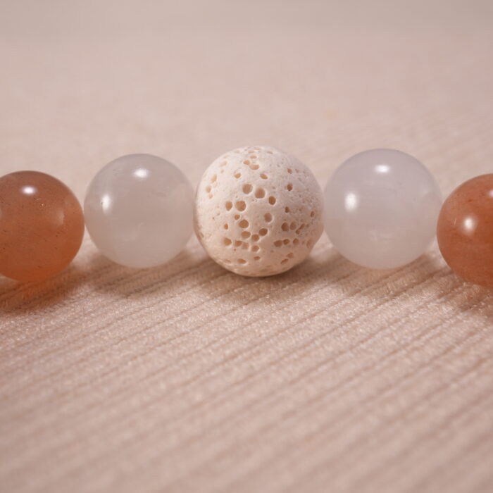 Detailed shot of porous lava stone contrasted with smooth, glossy gemstone textures.