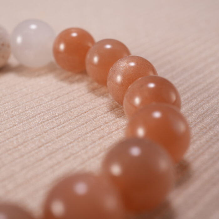Detailed shot of porous lava stone contrasted with smooth, glossy gemstone textures.