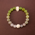 Handmade bracelet made with Lava Stone, Green Chalcedony, and White Chalcedony beads displayed on a clean background.