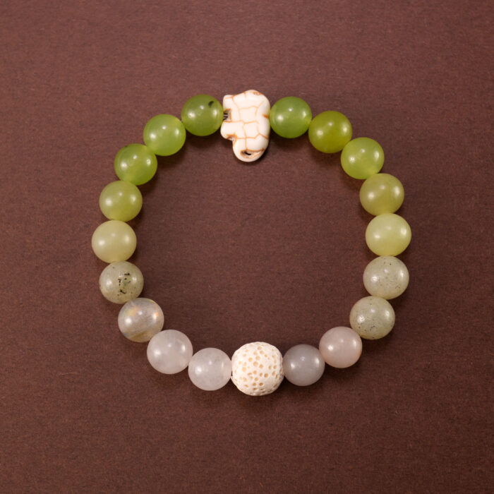 Handmade bracelet made with Lava Stone, Green Chalcedony, and White Chalcedony beads displayed on a clean background.