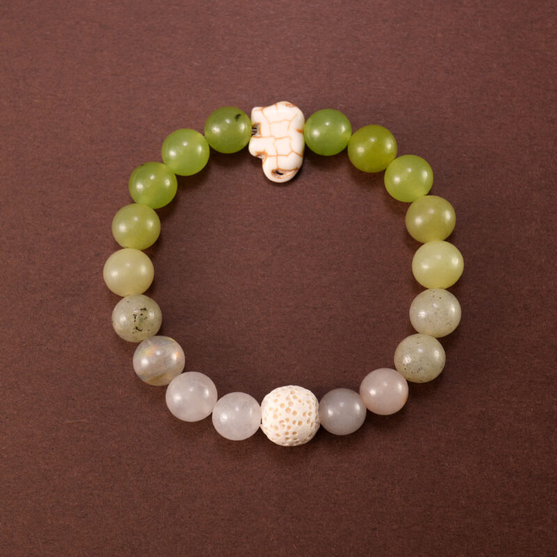 Handmade bracelet made with Lava Stone, Green Chalcedony, and White Chalcedony beads displayed on a clean background.