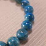 Macro shot showing the porous texture of Lava Stone and the translucent quality of Fluorite beads.