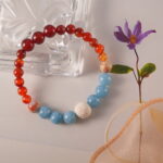 Detailed image showing the harmonious blend of Red Agate, Shoushan Stone, and Blue Chalcedony beads in the handmade design.