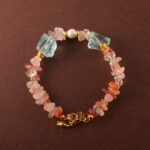 Handmade Leo zodiac bracelet featuring Fire Quartz, Pearl, and Aquamarine beads arranged in a minimalist design.