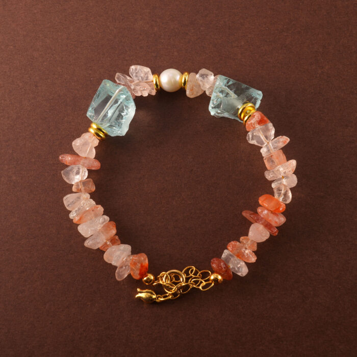 Handmade Leo zodiac bracelet featuring Fire Quartz, Pearl, and Aquamarine beads arranged in a minimalist design.