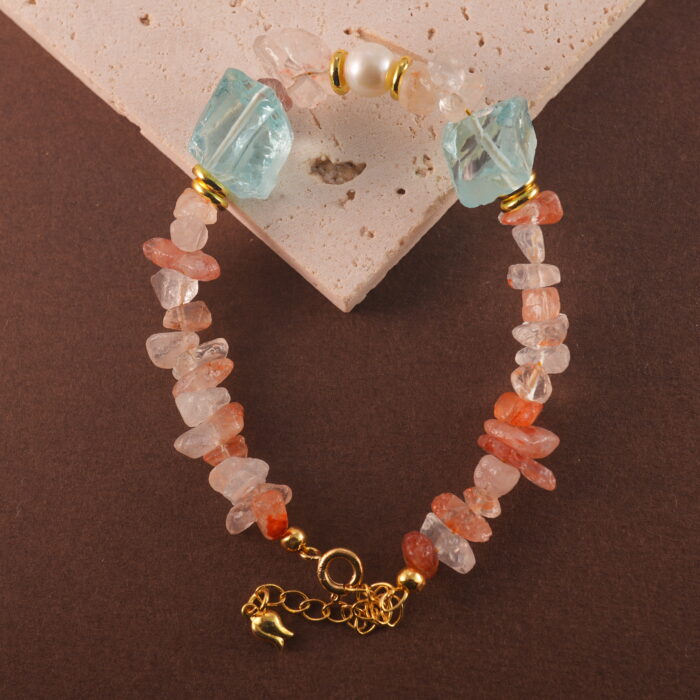 Detailed view highlighting the texture and natural inclusions of Fire Quartz, set between Pearl and Aquamarine.